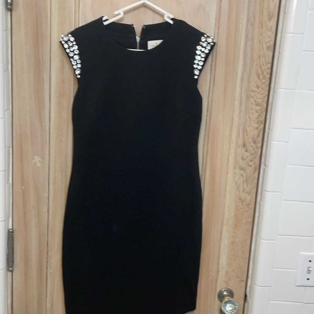 elegant black l dress with gem designs.